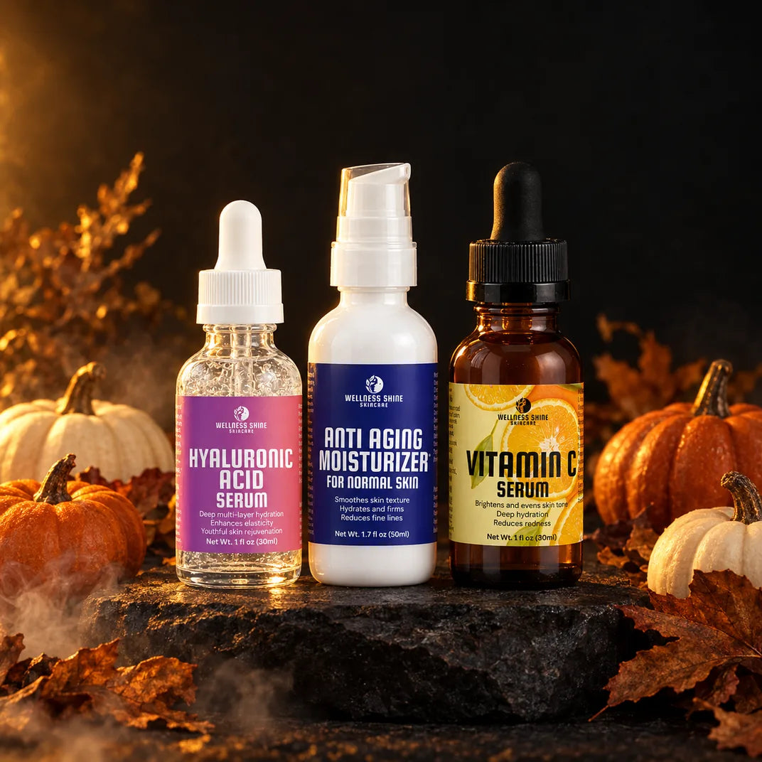 Wellness Shine Hyaluronic Acid Serum, Anti-Aging Moisturizer, and Vitamin C Serum on dark stone with pumpkins and autumn leaves.